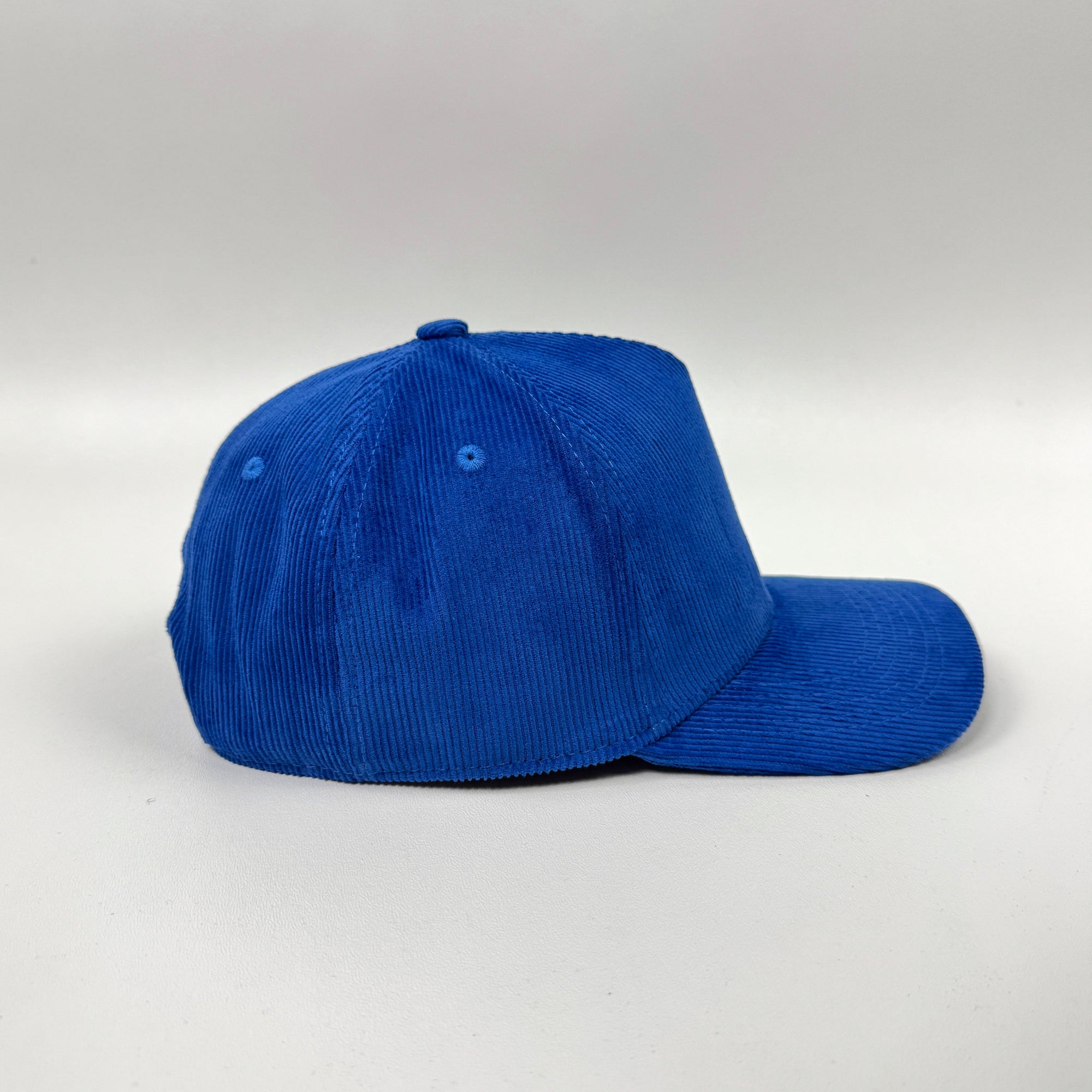 Blue corduroy cap on white background
